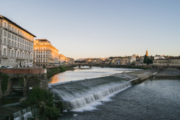 Old dam across the Arno river in Florence, Italy