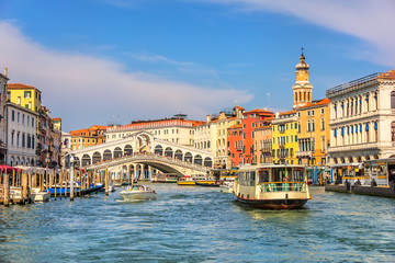 The Rialto Bridge and a vaporetto in a canal of Venice - obrazy, fototapety, plakaty