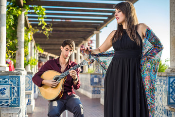 Band performing traditional music fado under pergola with azulejos in Lisbon, Portugal