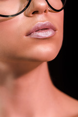 cropped shot of woman with pink lipstick on lips isolated on black