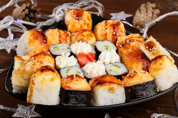 New Year and Christmas Sushi. Beautiful food photo with Christmas garland.