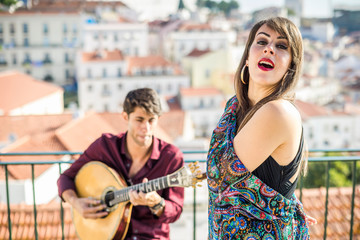 Beautiful fado singer performing with handsome portuguese guitarist player, Portugal