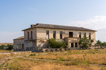 Fototapeta na wymiar Abandoned and ruined school. broken Windows. Abandoned destroyed houses. Abandoned villages in Crimea.