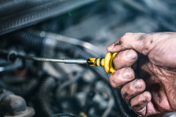 Auto mechanic working in garage. Repair service.