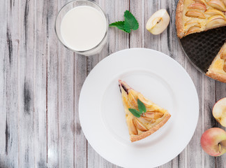 Homemade traditional apple pie. With mint. View from above. On a wooden background.