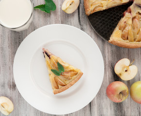 Homemade traditional apple pie. With mint. View from above. On a wooden background.