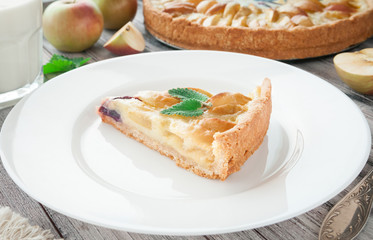 Homemade traditional apple pie. With mint. On a wooden background