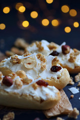 Bruschetta with cheese and granola over dark blue background with fairy lights