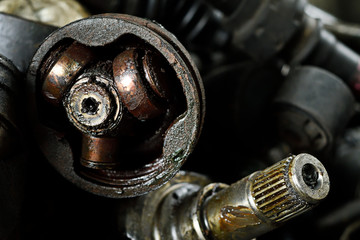 Closeup old ball bearing and drive shaft that connecting and transmits power to drive.