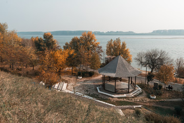 Wooden gazebo on Danube river promenade in autumn season.Romania