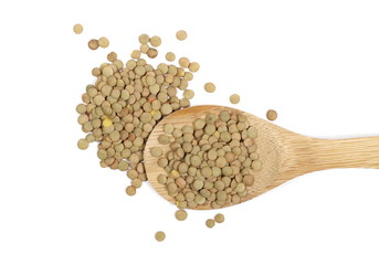 Pile of green lentils with wooden spoon isolated on white background. top view