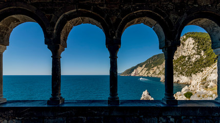 Stunning views of the sea through the external colonnade of the Church of San Pietro in Portovenere, Liguria, Italy