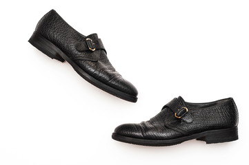 Black leather shoes with buckles on a white background. Trend