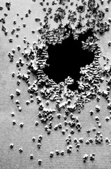Shooitng target full of bullet holes. Black and White