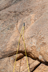 Climbing rope hooked on the first carabiner of the climbing path 