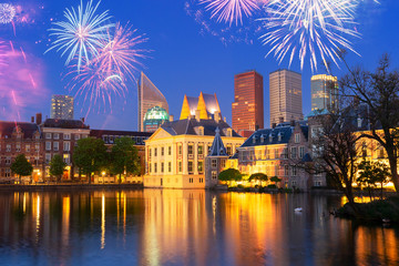 Mauritshuis illuminated and reflecting in pond at night with fireworks, Netherlands