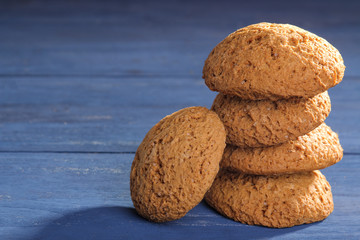 oatmeal cookies piled in a pile on a blue wooden table. bake. tasty plan