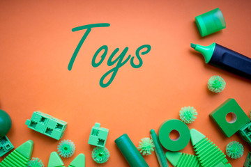 various kids toys background in green colours, colorful assorted