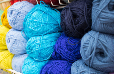 Coloured wool yarn into skeins and tangles. Bright yarn for knitting.