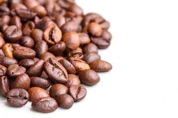 Roasted coffee beans isolated on a white background.