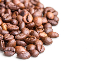 Roasted coffee beans isolated on a white background.