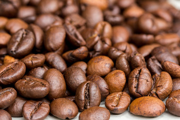 Roasted coffee beans isolated on a white background.