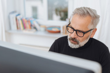 bearded businessman engrossed in his work