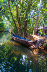 Traditional boat of Kerala Backwaters moored to the shore