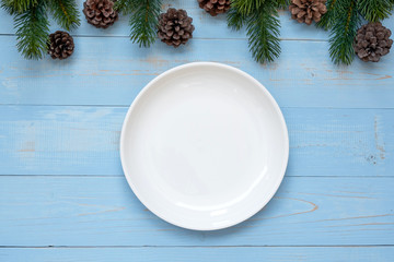 Obraz na płótnie Canvas Empty plate with Christmas decoration, preparation for Happy New Year and Xmas Holidays