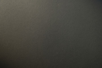 light gradient on a grey cardboard background