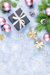 Festive Christmas background with fir branches, giftboxes, silver and golden decorations, copy space