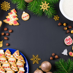 Tasty Christmas cookies, Christmas tree, decorations on black background. Christmas cooking concept