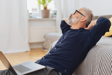 Middle-aged man relaxing on a sofa at home