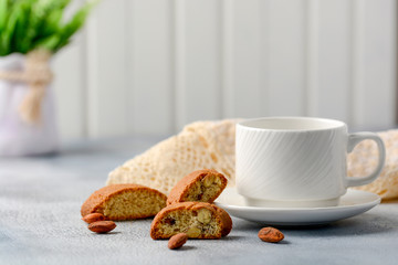 Good morning concept - breakfast frothy espresso coffee accompanied by delicious Italian almond cantuccini biscuits