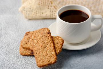 A cup of coffee with gluten-free cookies from cereals on the coffee table. Time have a bite