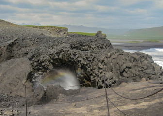 Dyrholaey cliffs and rainbow, South Iceland, Europe