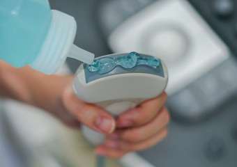 Ultrasonography (USG) hand holding ultrasound probe and coupling gel prepare for diagnostic.