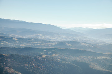 Fototapeta na wymiar hazy mountains landscape under blue sky, Carpathians, Ukraine