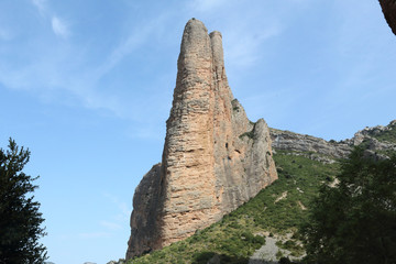 The high Mallos de Riglos rock formations and mountains, popular for climbers and excursionists, in Aragon, Spain, during a sunny summer day