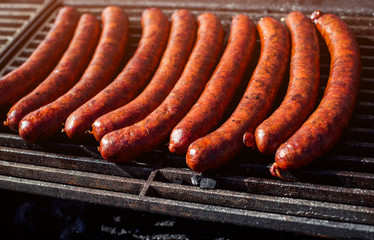 Grill sausages on on street food outdoor market. Fried baked sausages. European street food. Street food festival.