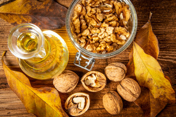 fresh walnuts and oil on an old wooden table