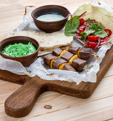Veal shashlik with green hummus and Dzadziki sauce with horseradish