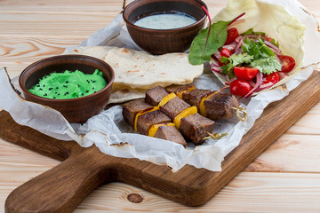 Veal shashlik with green hummus and Dzadziki sauce with horseradish