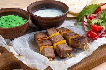 Veal shashlik with green hummus and Dzadziki sauce with horseradish