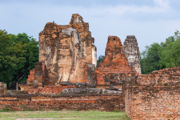 Fototapeta na wymiar The old buddha image on cement with ruins and ancient, Built in modern history in historical park is the UNESCO world heritage, Sukhothai Thailand.