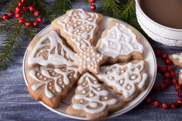 Christmas composition with ginger cookies and a cup of cocoa on the background of spruce branches