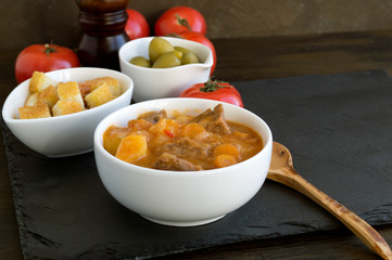 thick Hungarian soup, the goulash. on dark background.