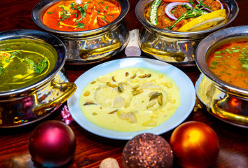 assorted indian curry and rice dishes shot from overhead composition