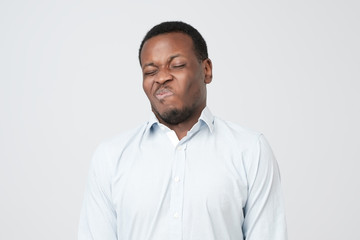 Disgusted young african american male looking in contempt, feeling loathing and disgust