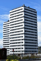 Obraz premium Modern architecture in the city. Residential black and white twin towers. Blue sky with clouds, La Coruña, Spain. 